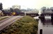 In Juli 1987 rangeren diesellocs 2326 en 2234 in Veghel over het kanaal met de graantrein uit Boxtel.  In Juli 1987 two diesel engines (NS 2326 and 2234) are crossing the bridge in Veghel while shunting with the cereal train.