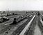 Het emplacement Watergraafsmeer in Amsterdam. Gezien vanaf het dak van de lijnwerkplaats. Er zijn diverse diesellocomotieven zichtbaar op de foto. 
Rond 1955.
Beeldmateriaal Het Utrechts Archief Nr. 168696
 The yard Watergraafsmeer in Amsterdam, seen from the roof of the maintenance facility. 
On the tracks we can see various diesel engines. 
Around 1955
Image from Het Utrechts Archief Nr. 168696 